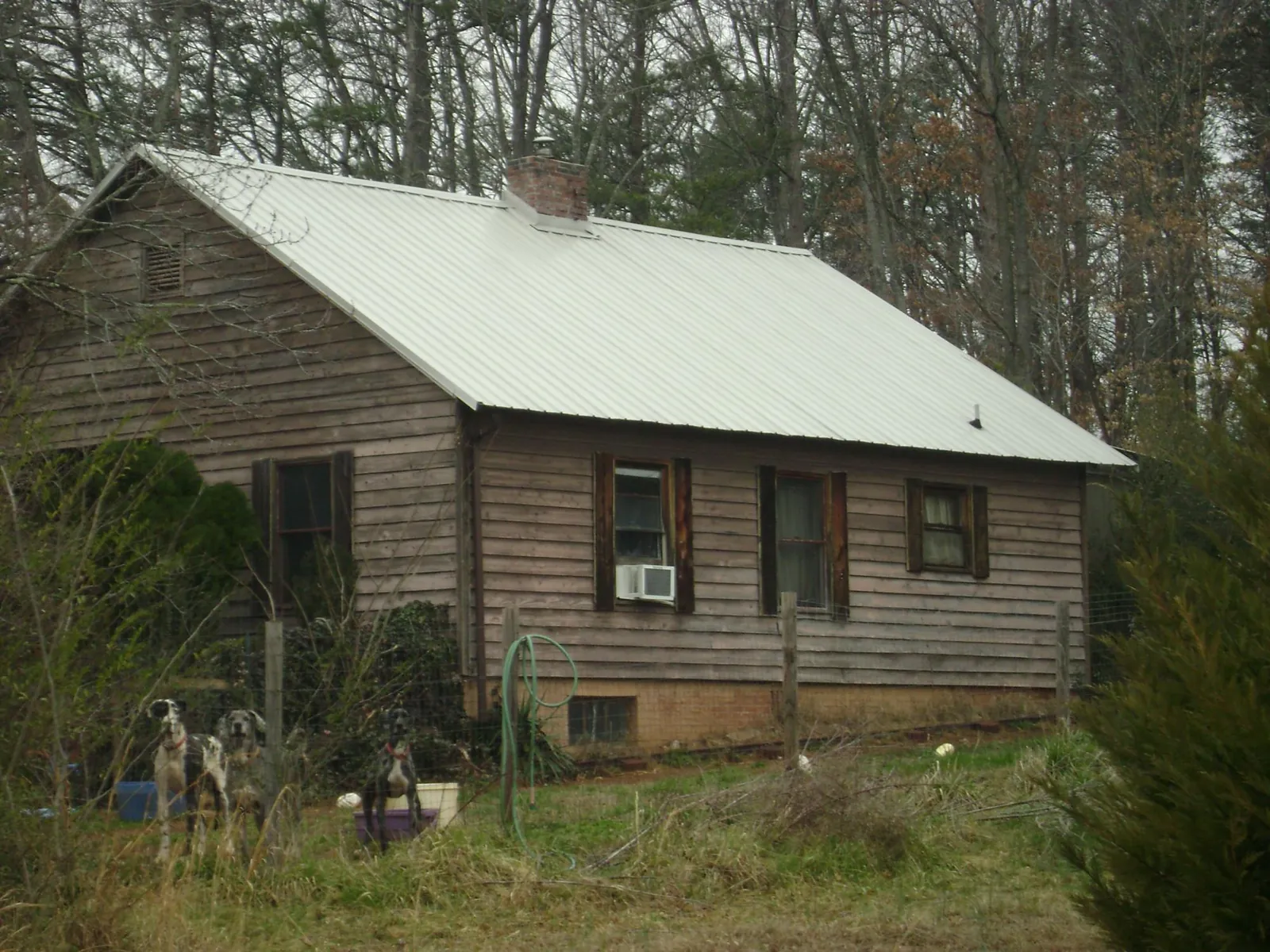 White metal roof on an old wood sided farmhouse, from a Metal Roof Installation job in Glouster